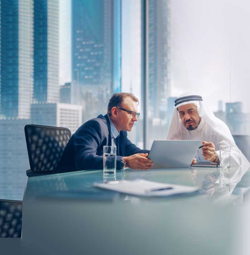 a business consultant advising businessman in office at desk